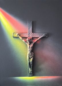 Christ on the Cross under a rainbows llight.